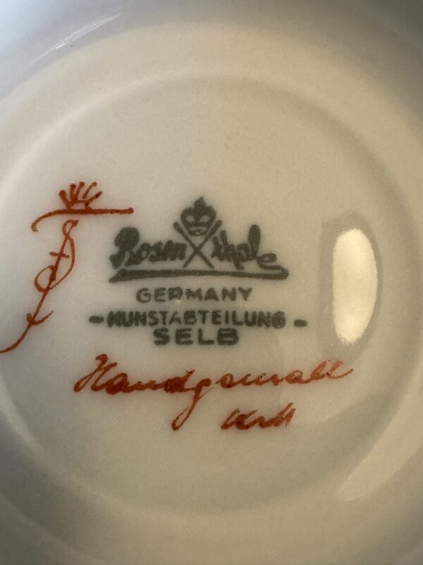 The image shows the underside of a porcelain item marked with intricate stamps. It features a green Rosenthal crown and crossed lines logo, “GERMANY KUNSTABTEILUNG SELB,” and handwritten red script reading “Handgemalt” with a signature-like mark.