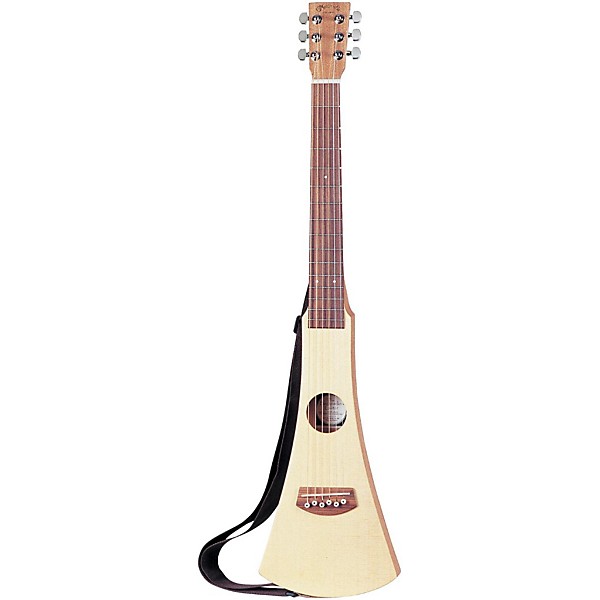 A small, narrow-bodied acoustic travel guitar with a light wood finish, six strings, and a black strap attached, standing upright against a white background.