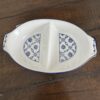 A white and blue dish on a wood surface.