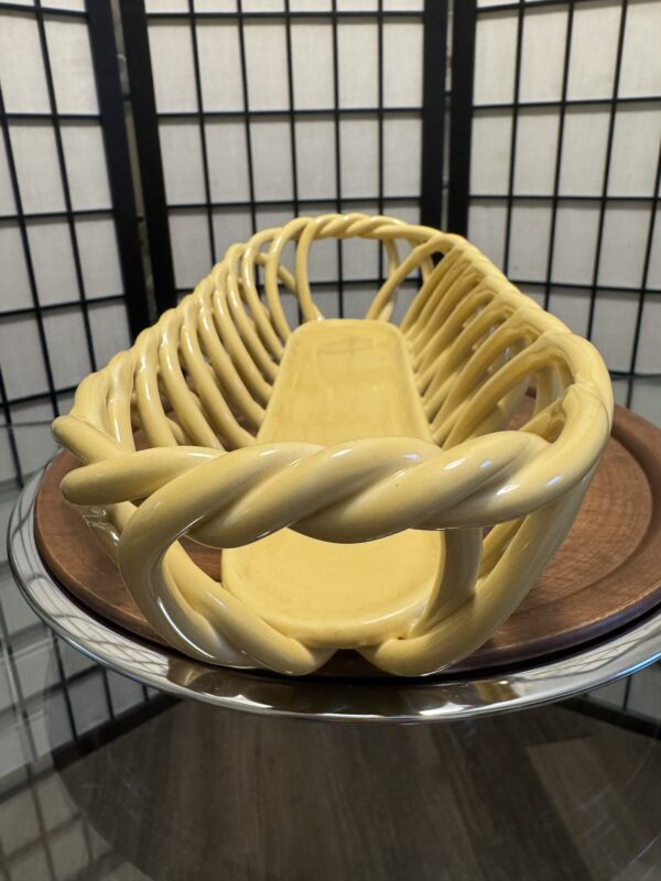 A yellow basket on a plate.
