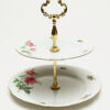 The Tiered Porcelain Serving Tray features a stylish handle, perfect for elegant presentation.