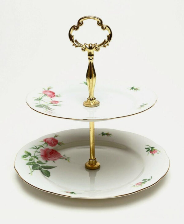 The Tiered Porcelain Serving Tray features a stylish handle, perfect for elegant presentation.