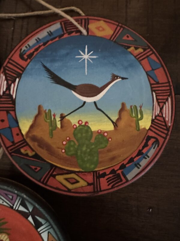 The Chinese Blue & White Miniature Vase features geometric patterns inspired by traditional designs, with a round shape and includes a hanging string for display.