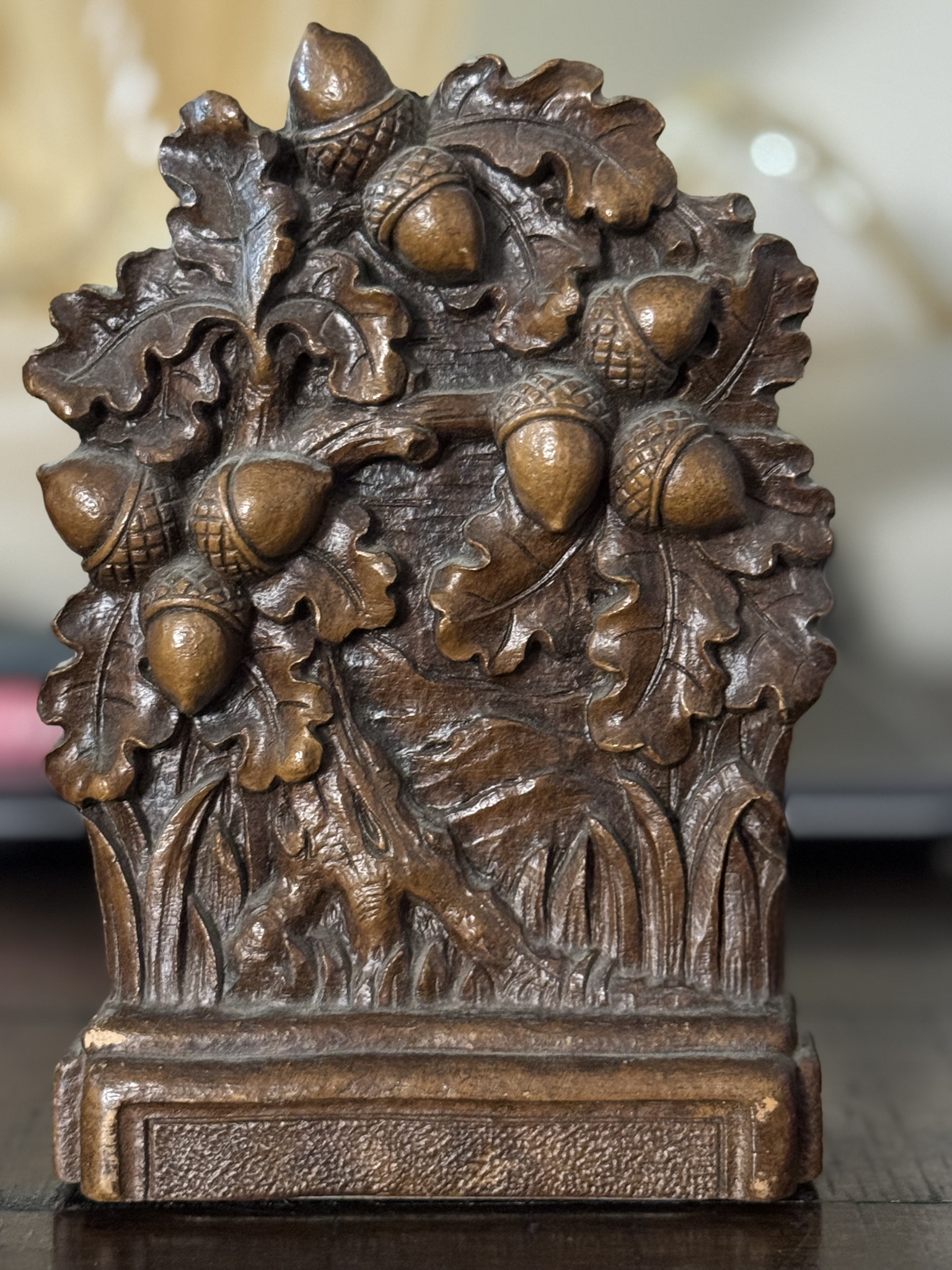 The Chinese Blue & White Miniature Vase features detailed oak leaves and acorns clustered together, with a rectangular ornate base that complements its raised, three-dimensional leaf and acorn design.