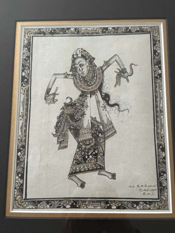 Traditional Balinese ink and watercolor drawing of a dancer in elaborate patterned attire, adorned with jewelry and headdress. The dancer strikes a dynamic pose, holding a dagger and a snake. Intricate floral border surrounds the artwork. Artist’s signature bottom right.