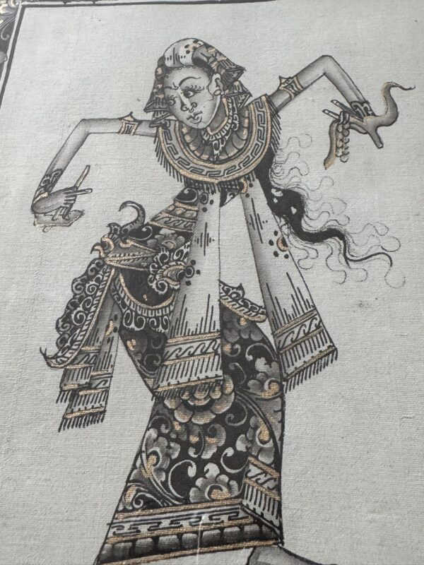 A detailed mural in black, white, and gold shows a stylized female dancer in traditional attire, adorned with ornate jewelry. Her arms are raised in expressive gestures, and swirling patterns decorate her clothing, creating a sense of movement and elegance.