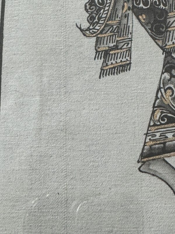 Close-up of an ornate patterned garment sleeve and lower hem, featuring intricate black, gold, and white designs on textured fabric. Only a portion of the outfit is visible, emphasizing the detailed decoration and craftsmanship.