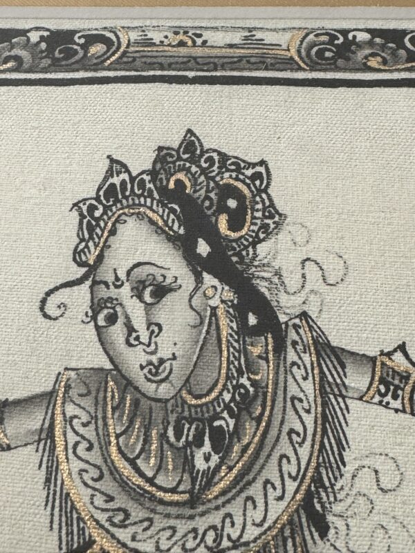 A detailed black, white, and gold illustration of a dancer wearing ornate jewelry and a headdress with intricate patterns. The dancer’s expressive face and flowing costume show stylized lines and decorative flourishes on textured fabric.